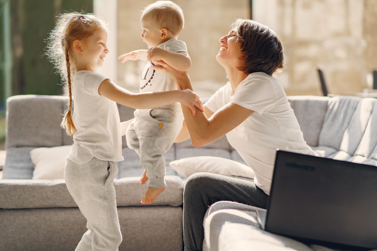 A mother playing with her children at home