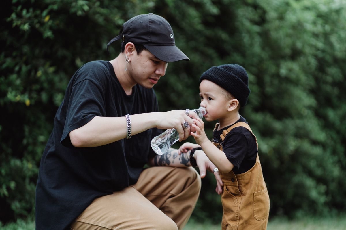 A mother helping her child take medicine